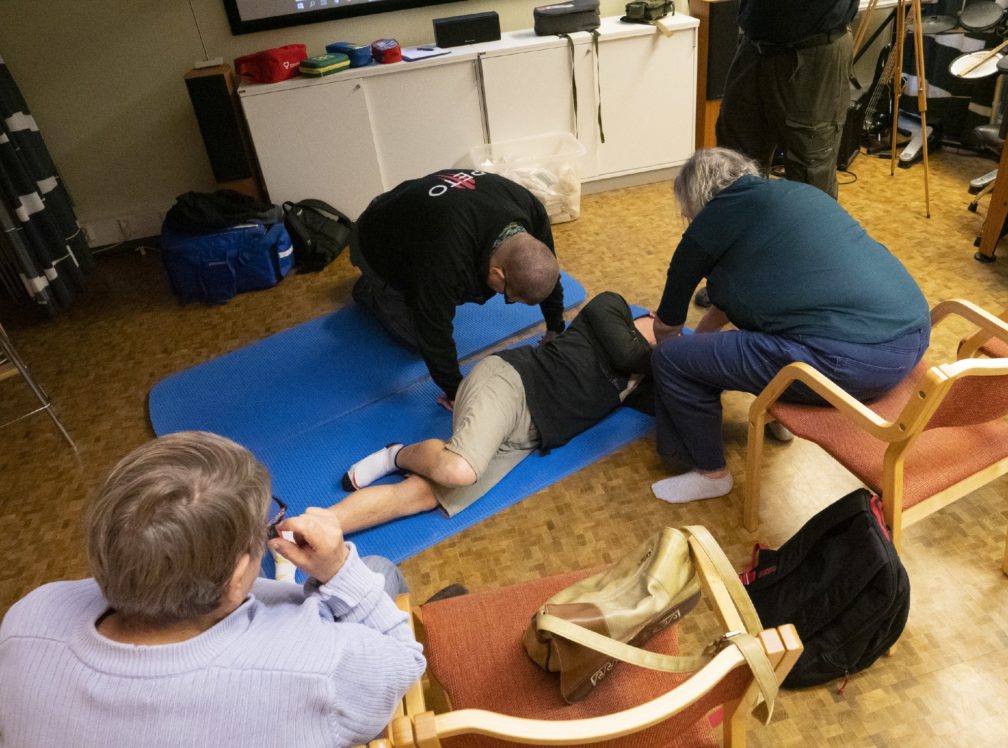 Kurssilaiset harjoittevat ryhmissä tajuttomalle annettavaa ensiapua.
